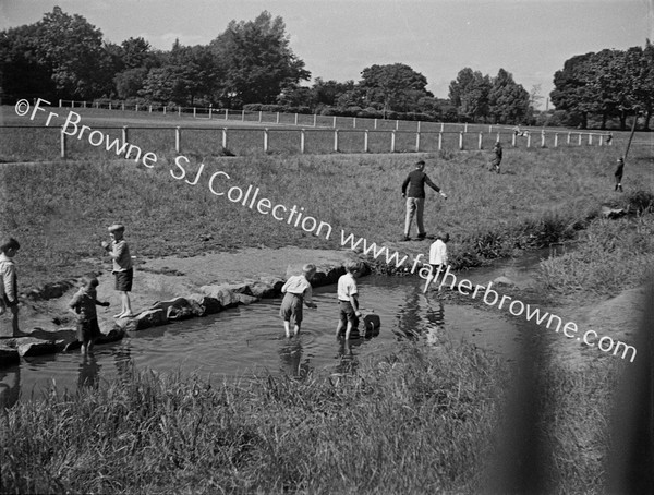 CHILDREN FISHING FOR PINKEENS  NEAR RACE COURSE